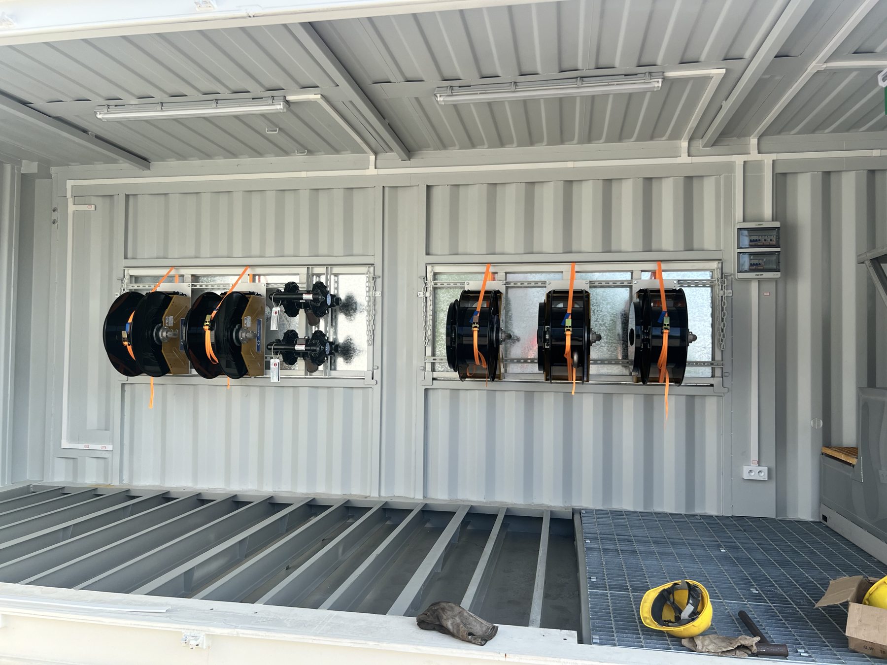 Service equipment and hose reels inside a fabricated container
