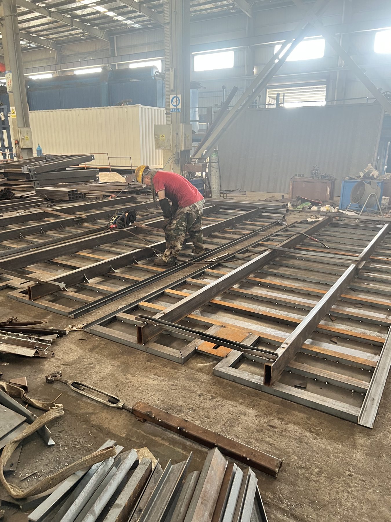 Steel components laid out for fabrication in the workshop